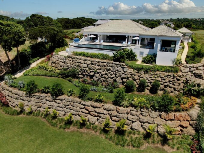Terraced gardens and coral stone walls below the pool terrace at Horizons villa