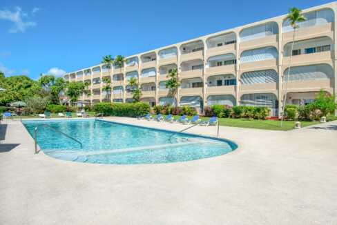 Communal pool and apartment building exterior at Golden View 106, Holetown