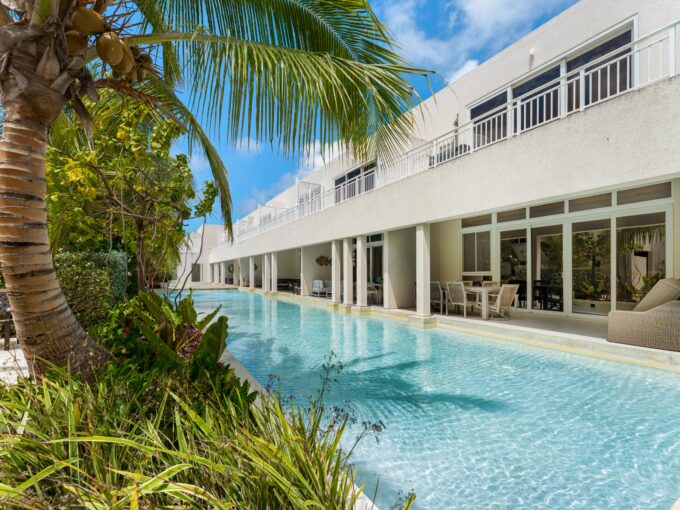 Exterior of Harmony Hall Green with communal pool, a furnished apartment for sale in Christ Church, Barbados