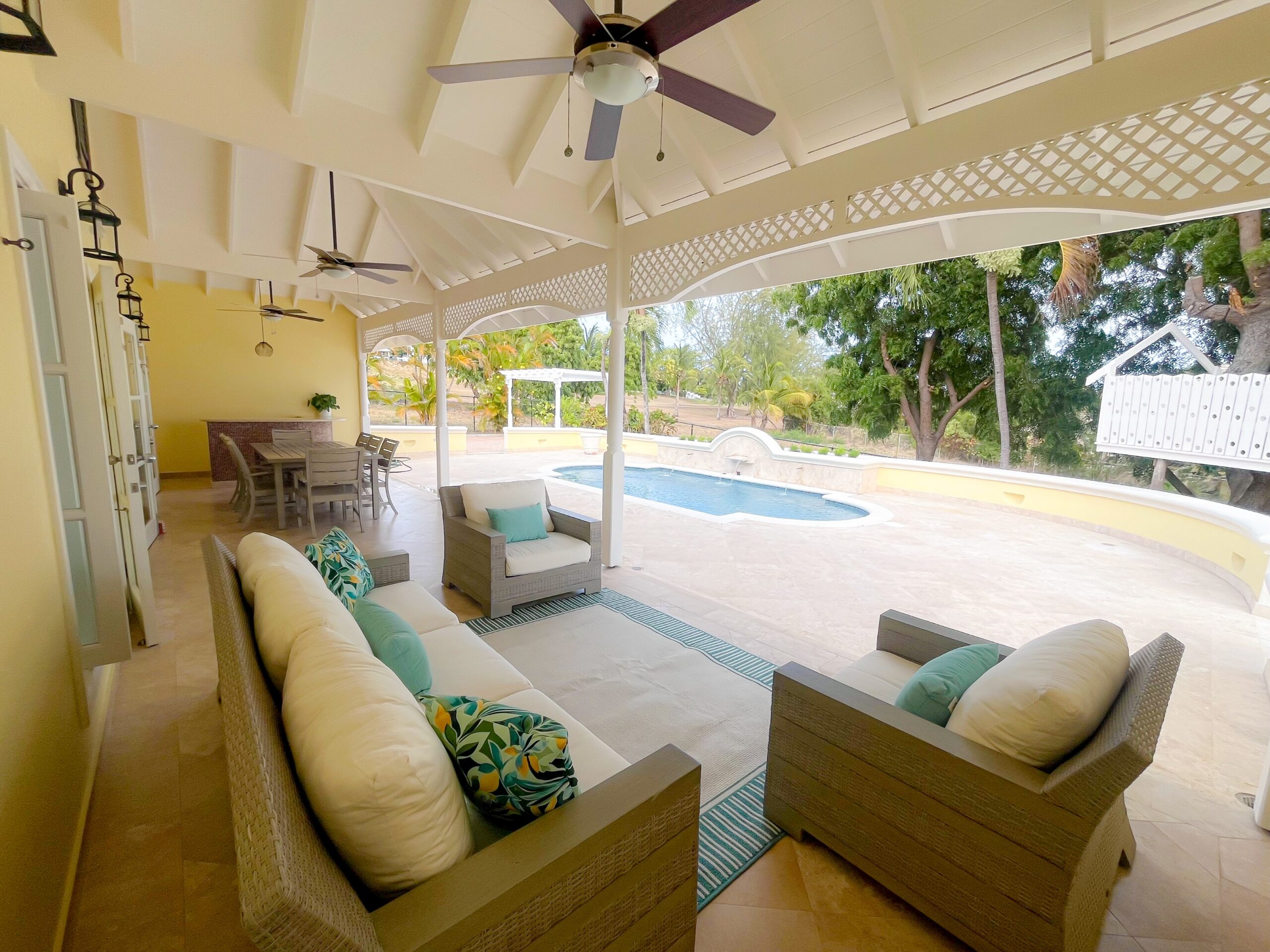 Private swimming pool with waterfall feature and golf course views at Looking Glass, Durants, Christ Church