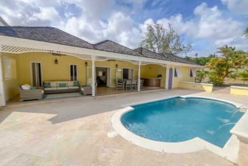 Private swimming pool with waterfall feature and golf course views at Looking Glass, Durants, Christ Church