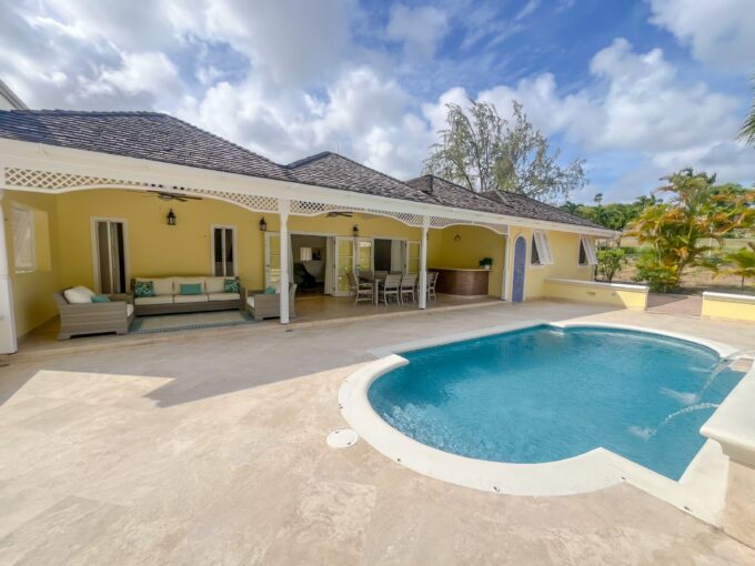 Private swimming pool with waterfall feature and golf course views at Looking Glass, Durants, Christ Church