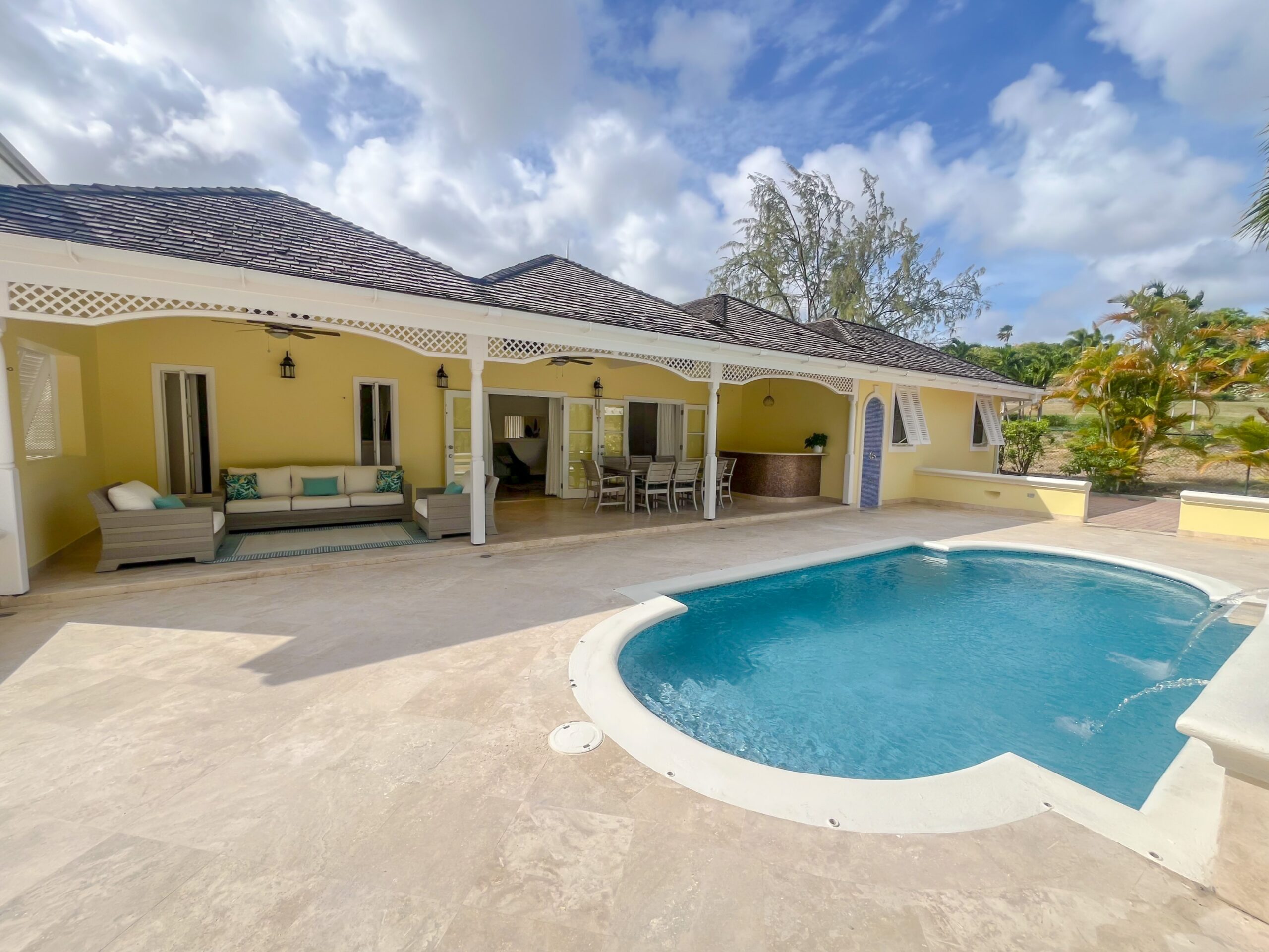 Private swimming pool with waterfall feature and golf course views at Looking Glass, Durants, Christ Church