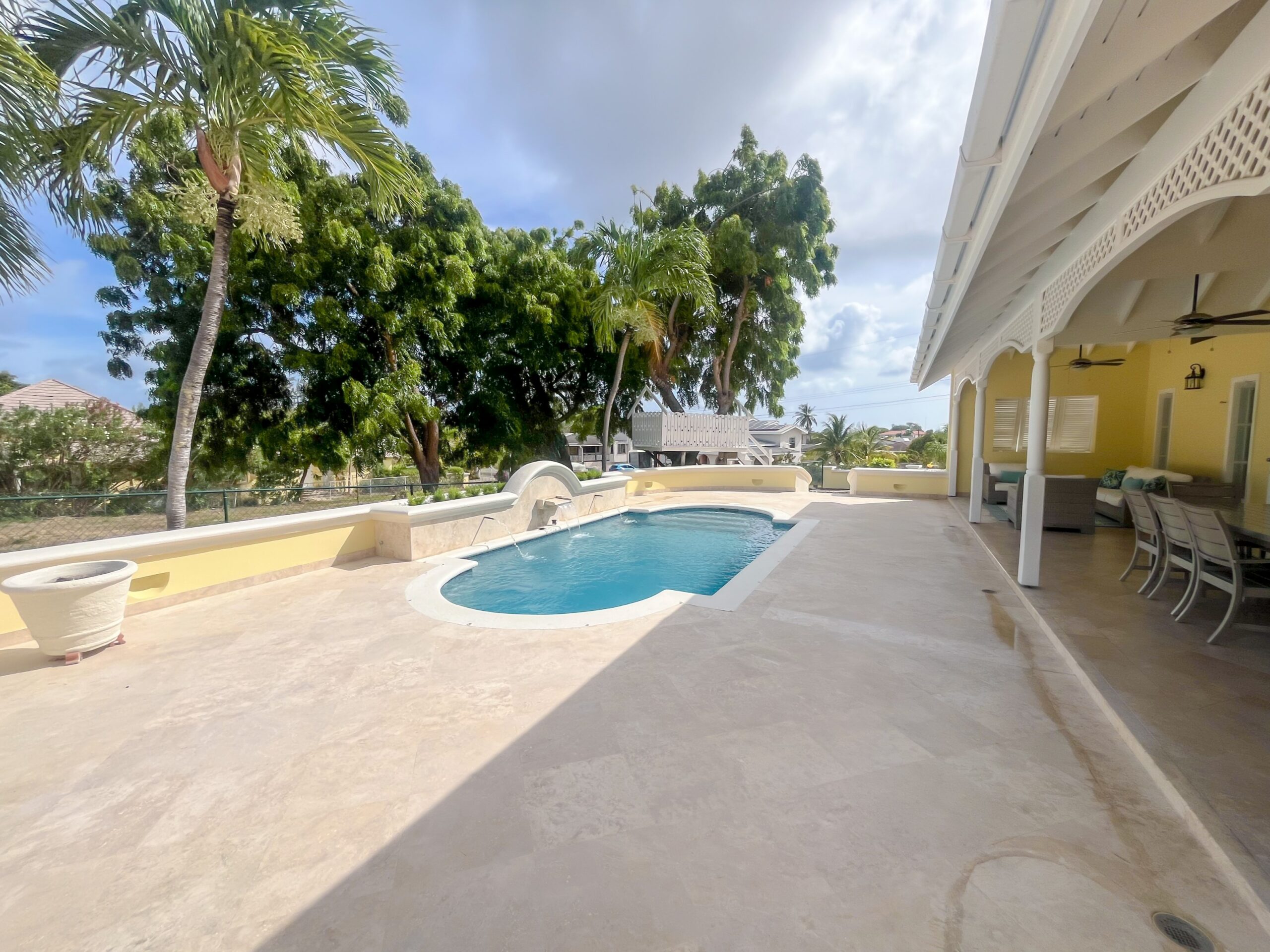 Private swimming pool with waterfall feature and golf course views at Looking Glass, Durants, Christ Church