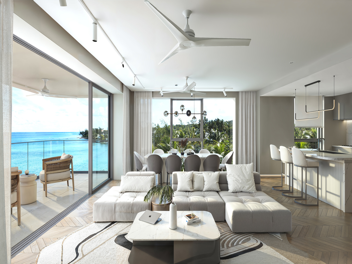 Open-plan living room opening to a sea-view balcony at Beyond, Mullins Bay, St Peter