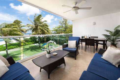 Balcony with al fresco dining and sea views at Ocean One 203, a beachfront apartment in Maxwell, Christ Church, Barbados