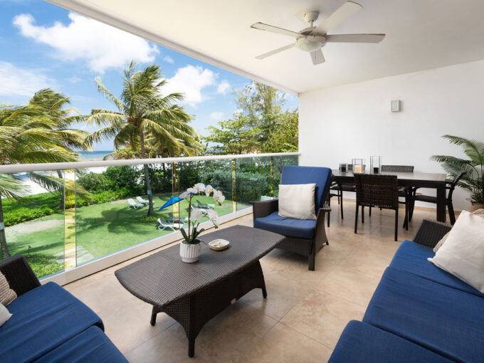 Balcony with al fresco dining and sea views at Ocean One 203, a beachfront apartment in Maxwell, Christ Church, Barbados