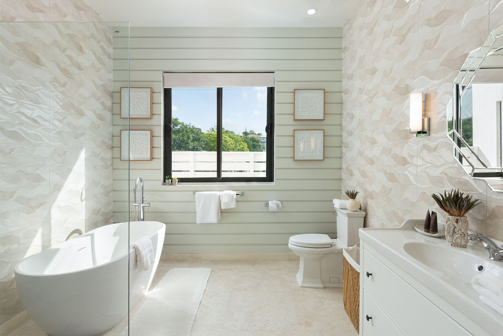 Bathroom with freestanding tub and vanity at Calico, a beachfront villa in St James, Barbados