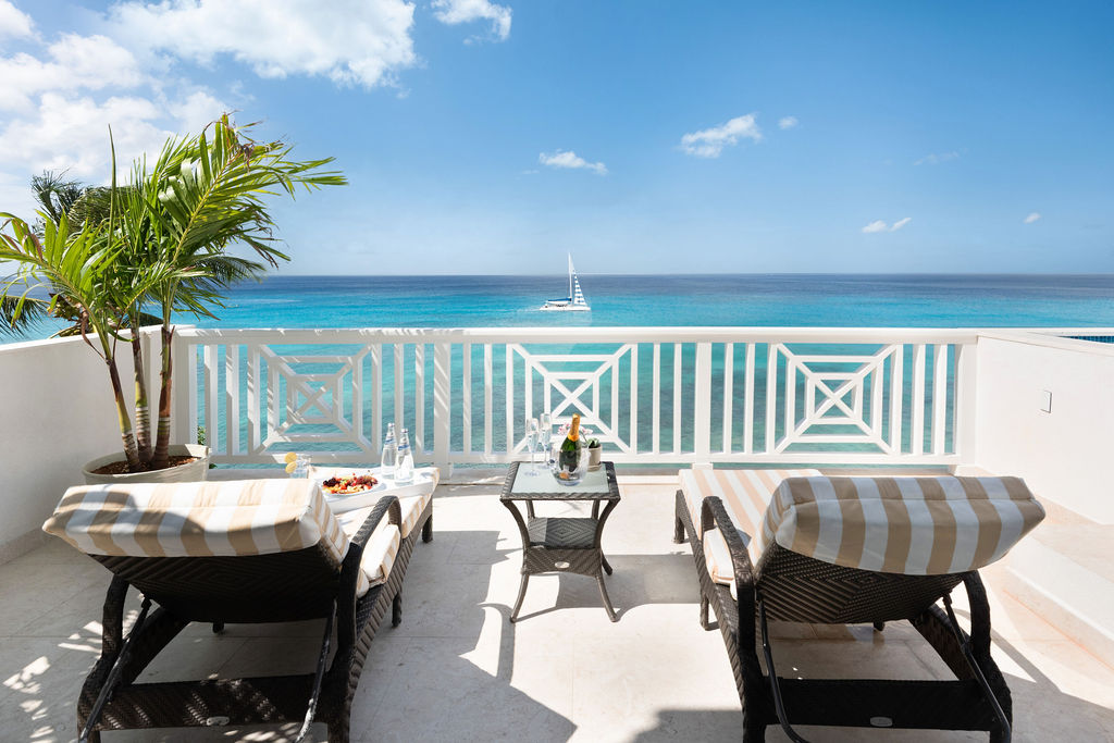 Covered terrace with dining and sea views at Calico, a beachfront villa in St James, Barbados