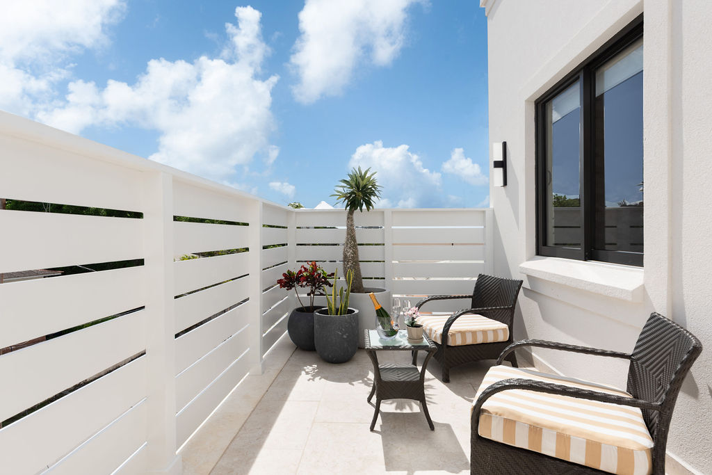 Terrace seating behind a privacy screen at Calico, a beachfront villa in St James, Barbados