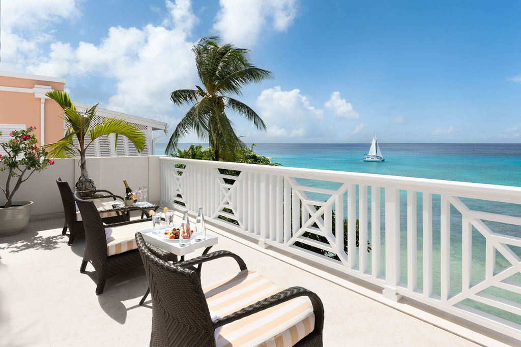 Balcony with palms and sea views at Calico, a beachfront villa in St James, Barbados