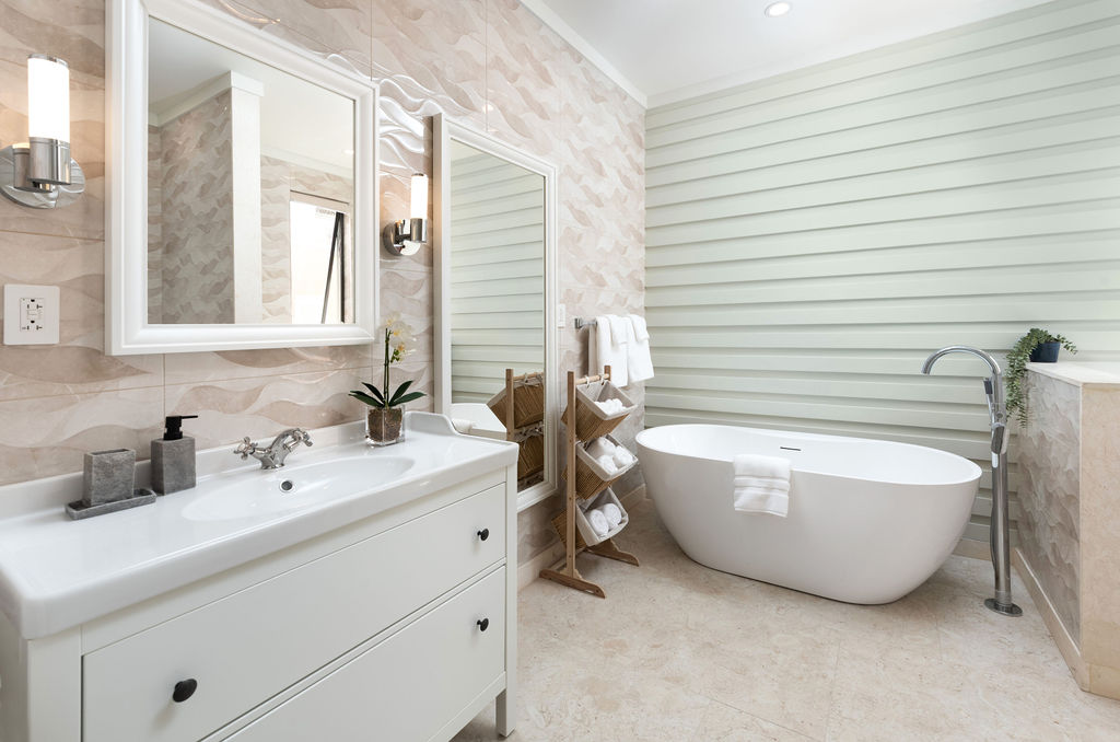 En-suite bathroom with a freestanding tub at Calico, a beachfront villa in St James, Barbados