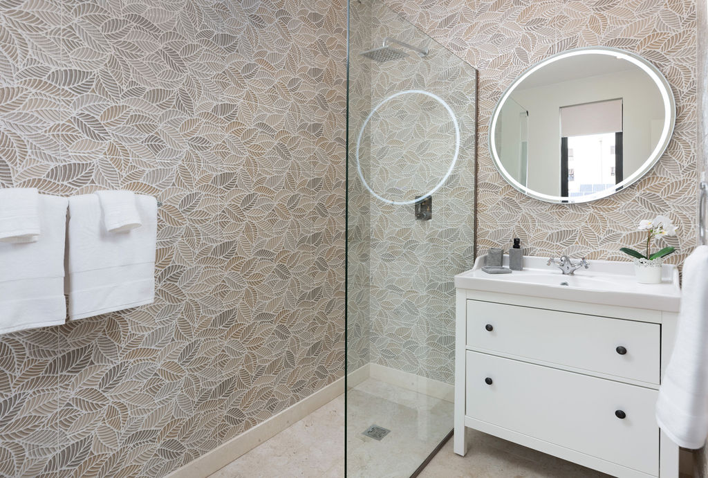 Bathroom with double vanity and walk-in shower at Calico, a beachfront villa in St James, Barbados