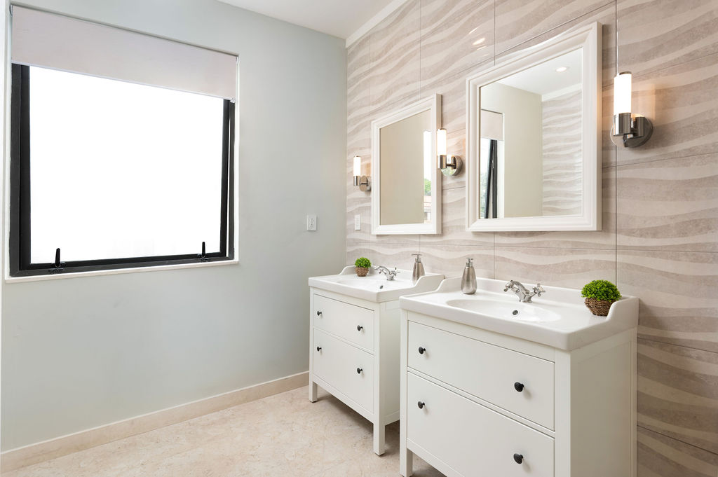Bathroom with vanity and mirror at Calico, a beachfront villa in St James, Barbados