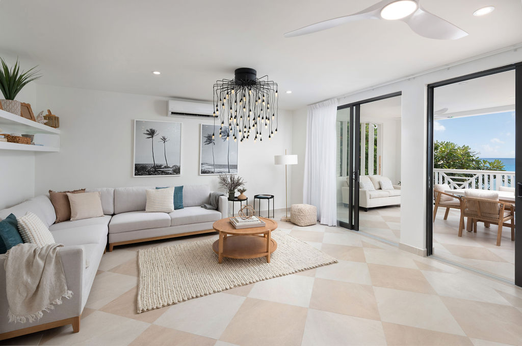 Living room opening to a sea-view terrace at Calico, a beachfront villa in St James, Barbados