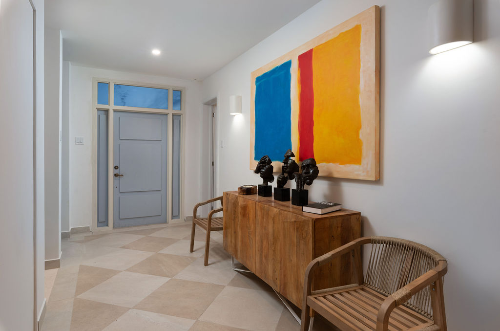 Entrance hall with statement artwork at Calico, a beachfront villa in St James, Barbados