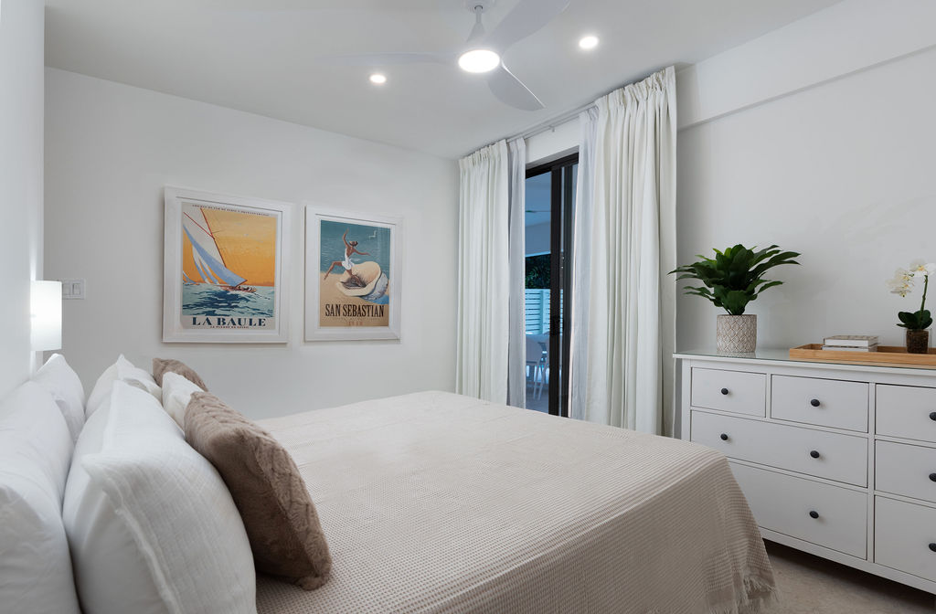 Bedroom with coastal artwork and dresser at Calico, a beachfront villa in St James, Barbados