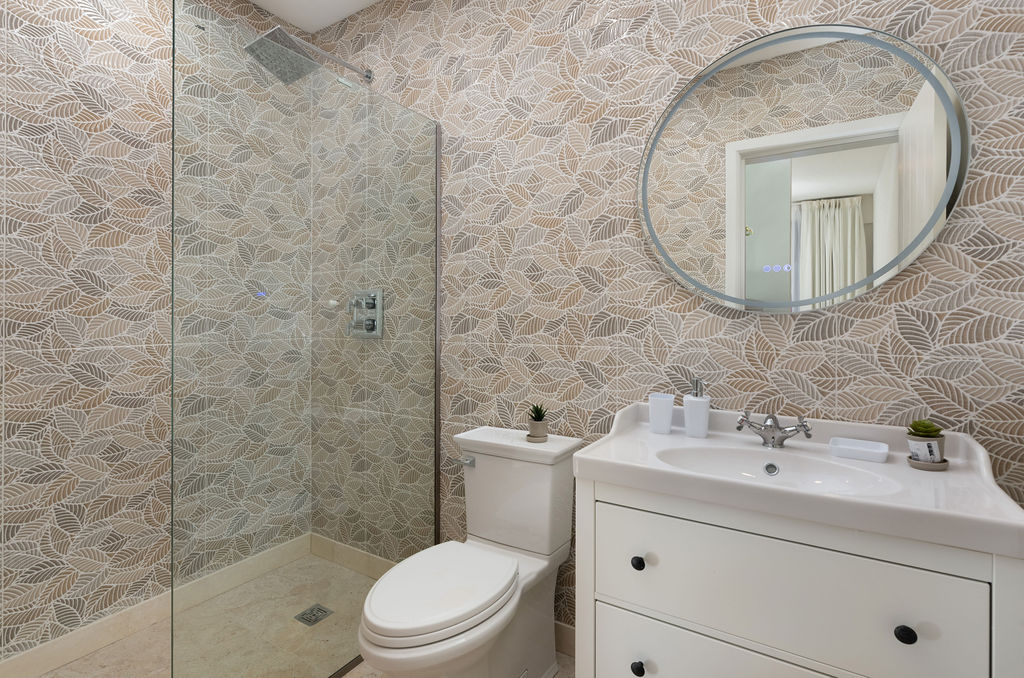 Bathroom with freestanding tub and vanity at Calico, a beachfront villa in St James, Barbados