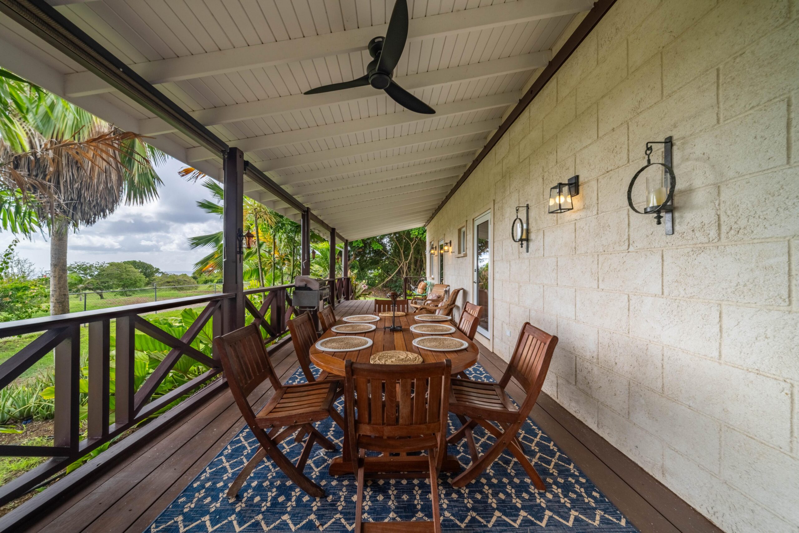 Covered veranda with a long dining table at 39 Blowers, St James