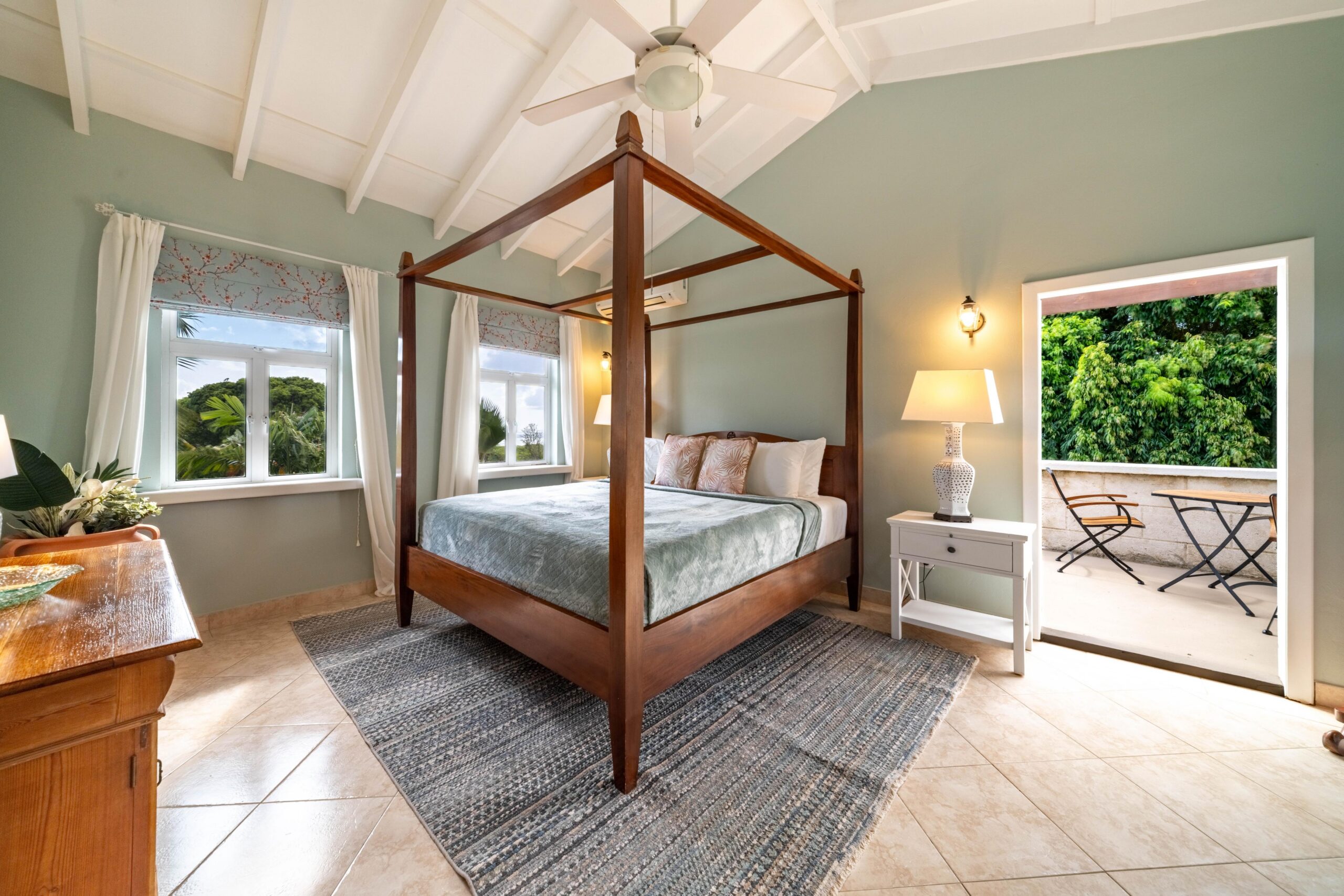 Bedroom with a four-poster bed opening to a balcony at 39 Blowers, St James