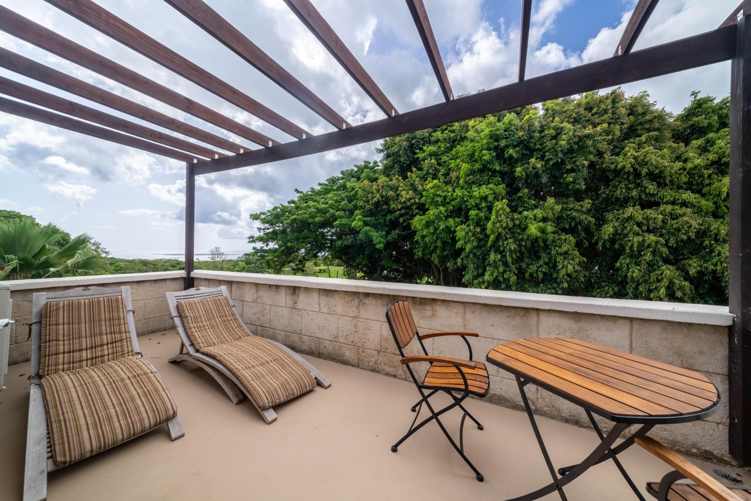 Balcony with sun loungers and garden views at 39 Blowers, St James