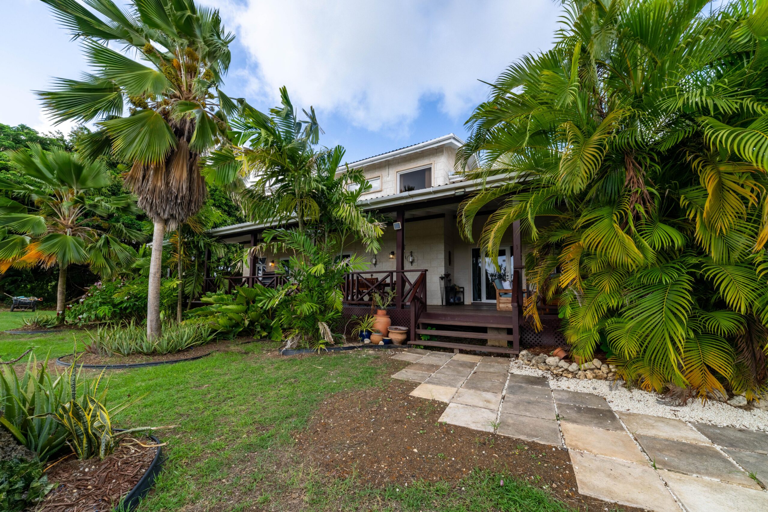 Exterior of the main house with tropical gardens at 39 Blowers, St James
