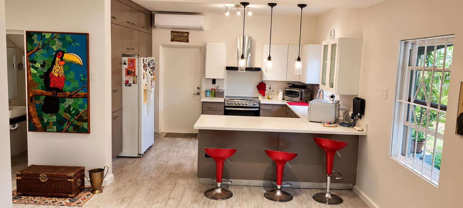 Open-plan kitchen with island and bar seating at Morningstar, The Palms, St George