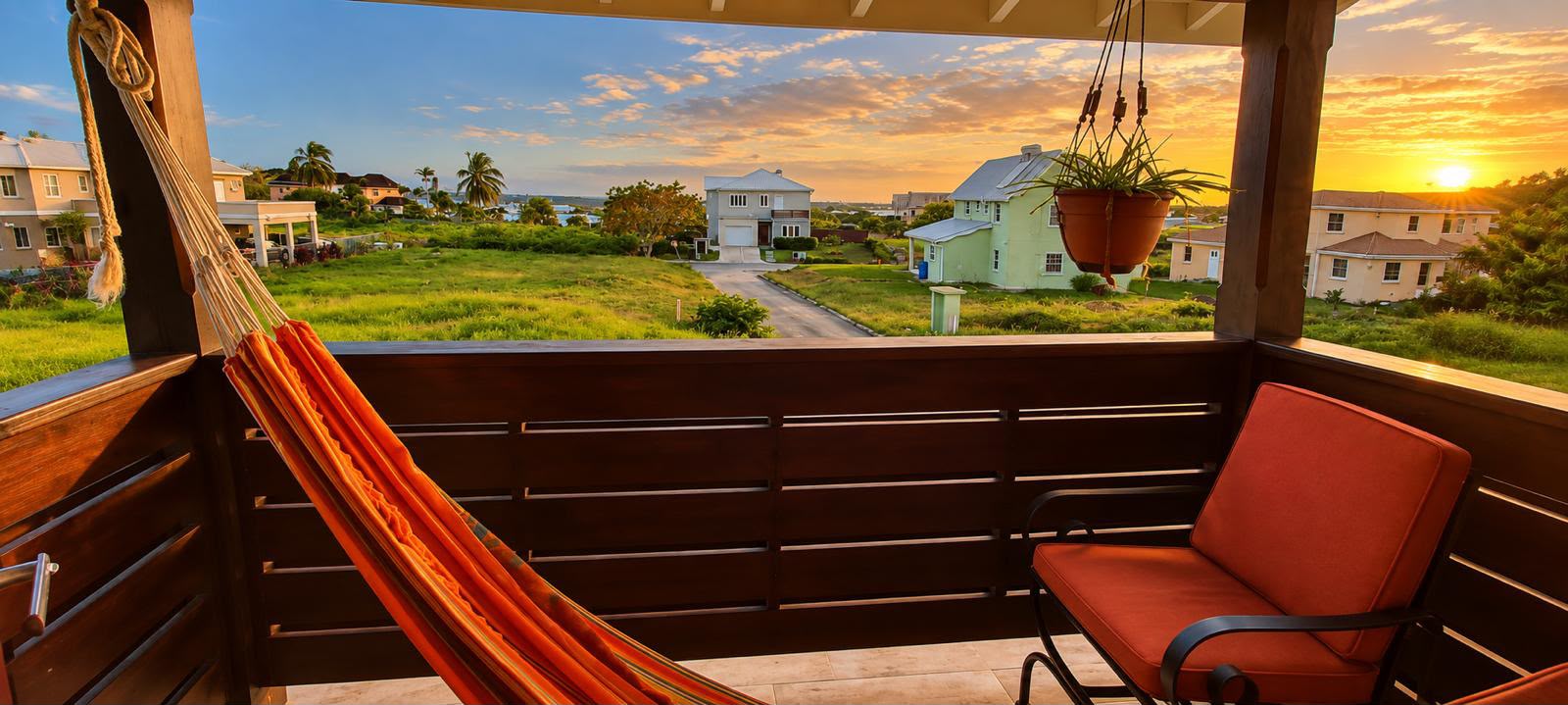 Balcony with a hammock and sunset views at Morningstar, The Palms, St George
