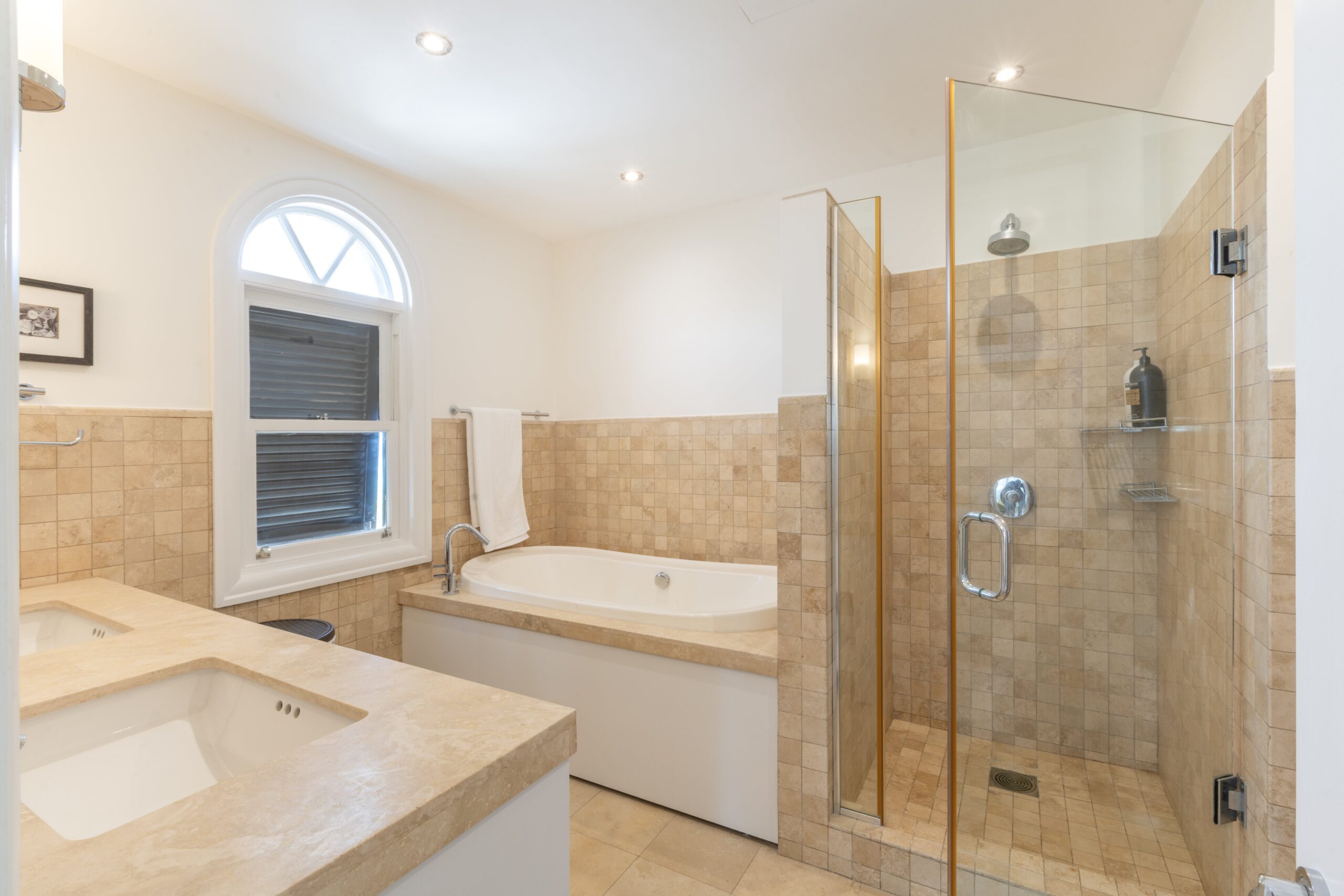 Bathroom with tub and glass shower at Sandy Cove 201, St James