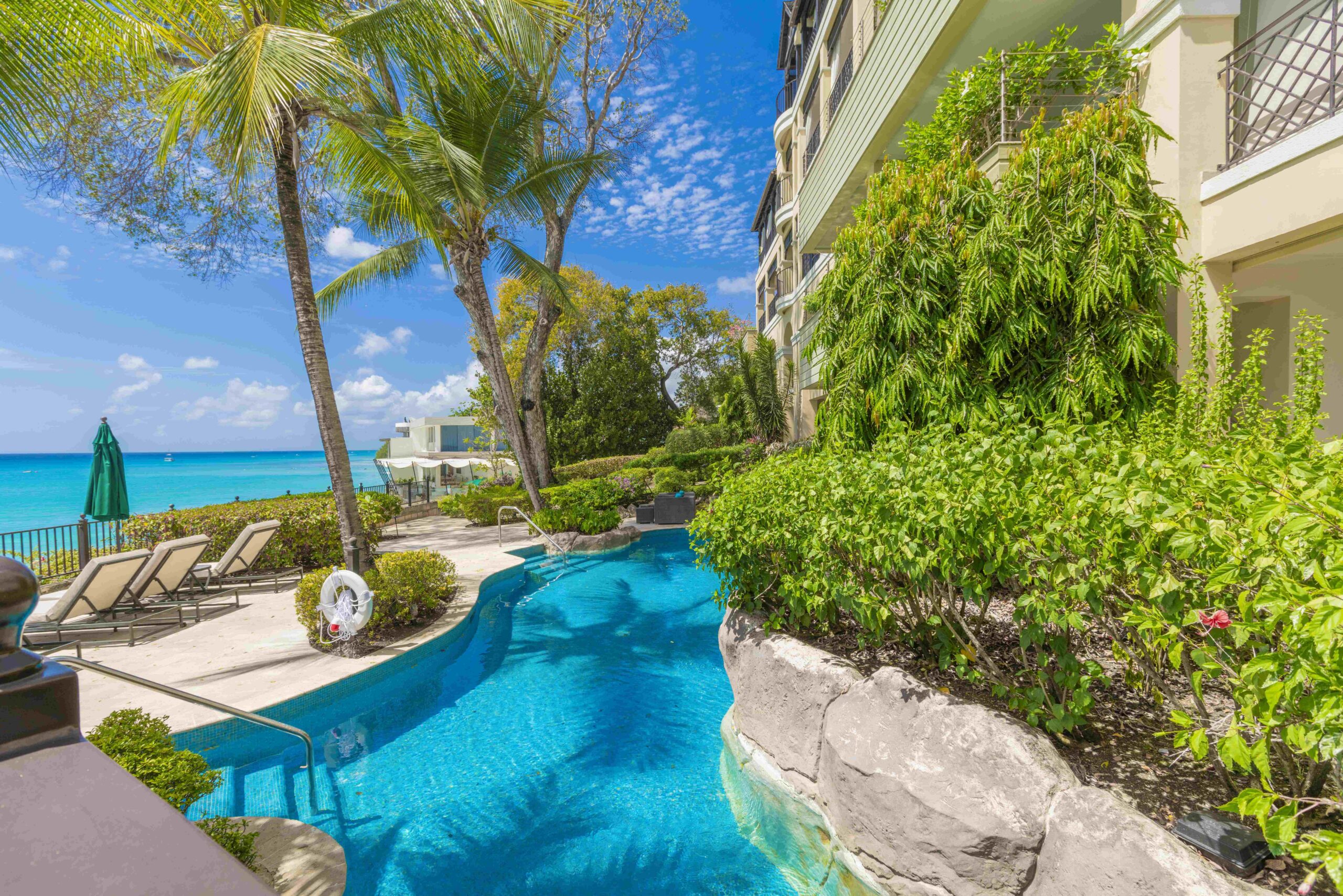 Communal pool and gardens by the beach at Sandy Cove 201, St James