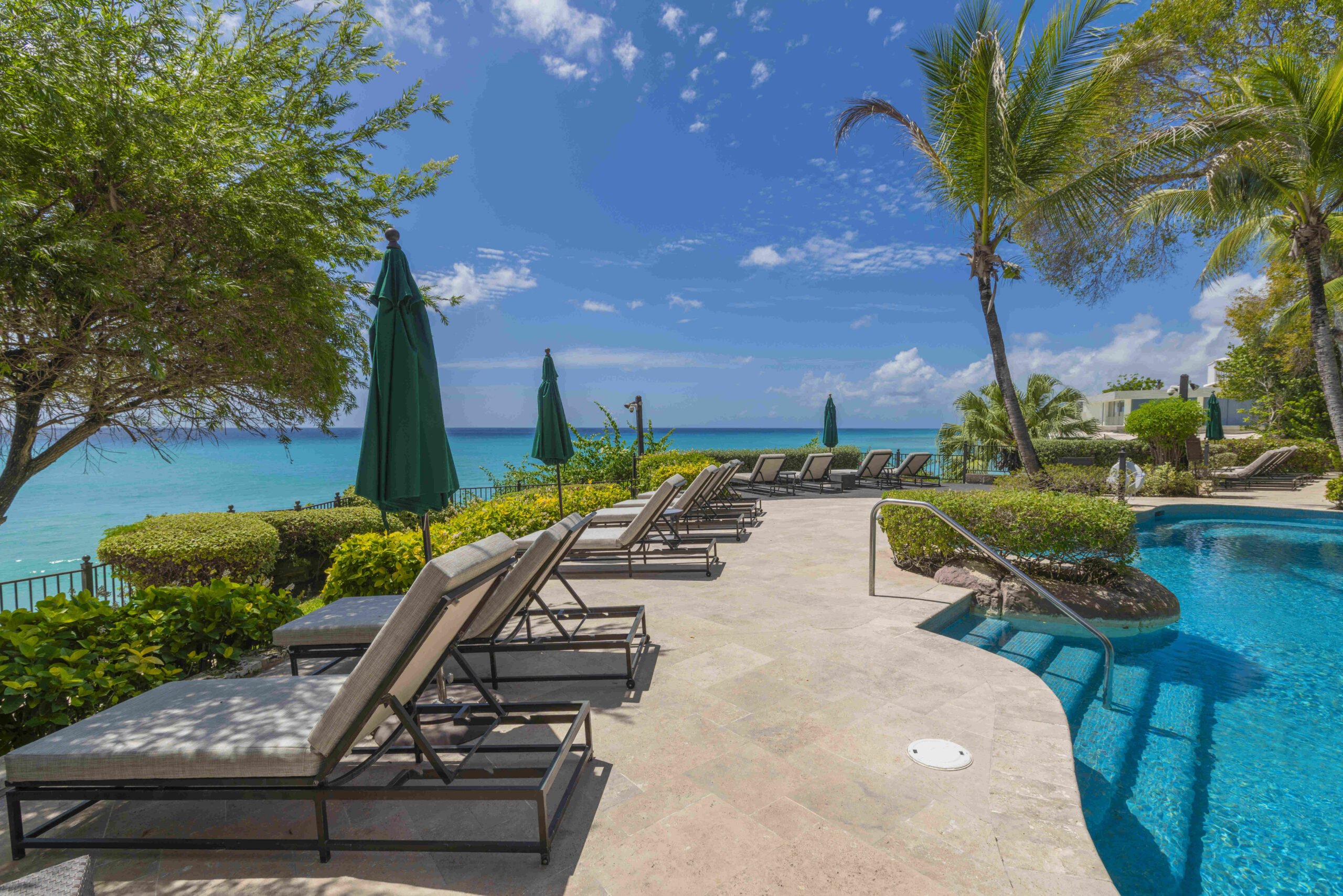 Beachfront communal pool with sun loungers at Sandy Cove 201, St James