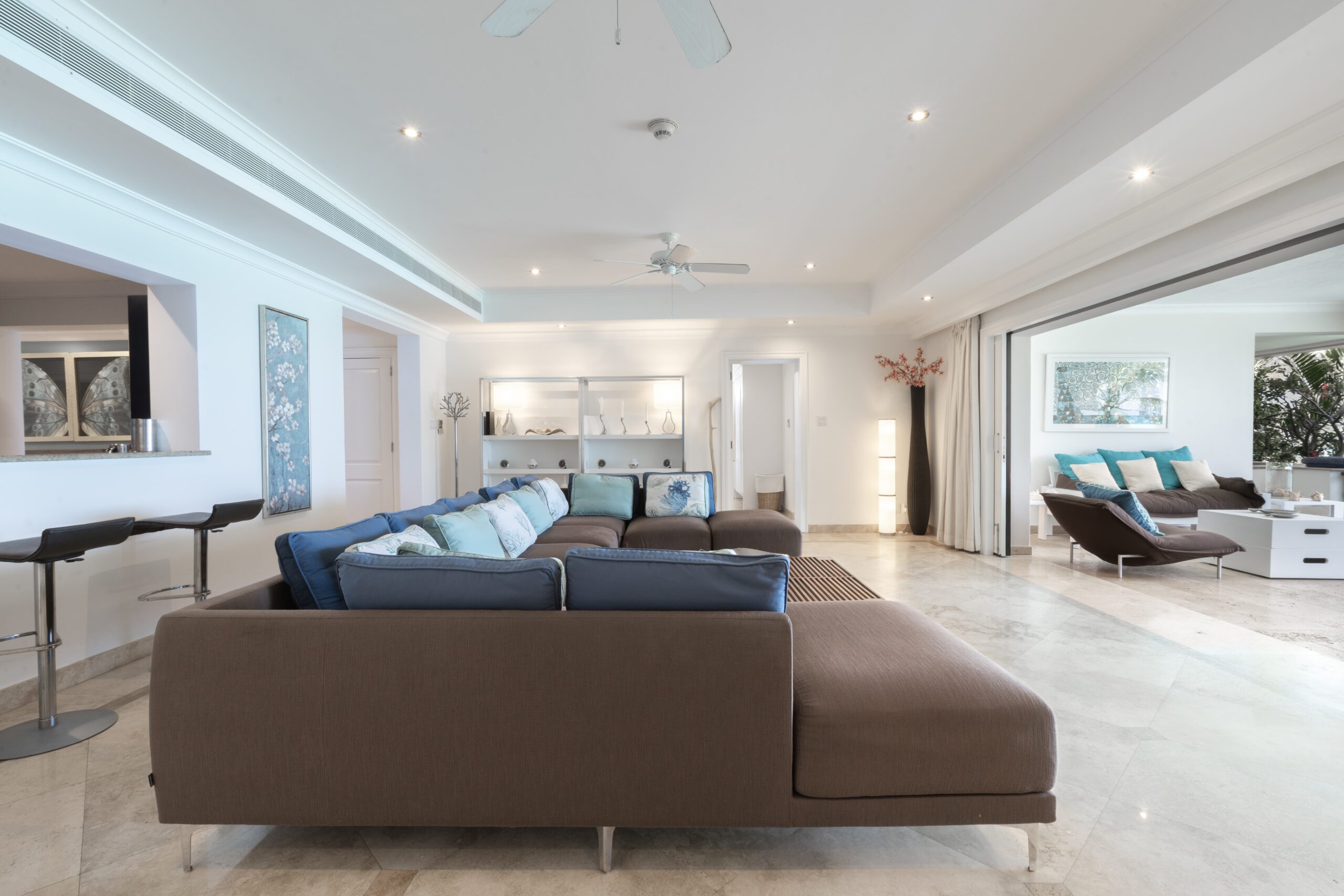 Spacious open-plan living area with terrace access at Sandy Cove 201, St James
