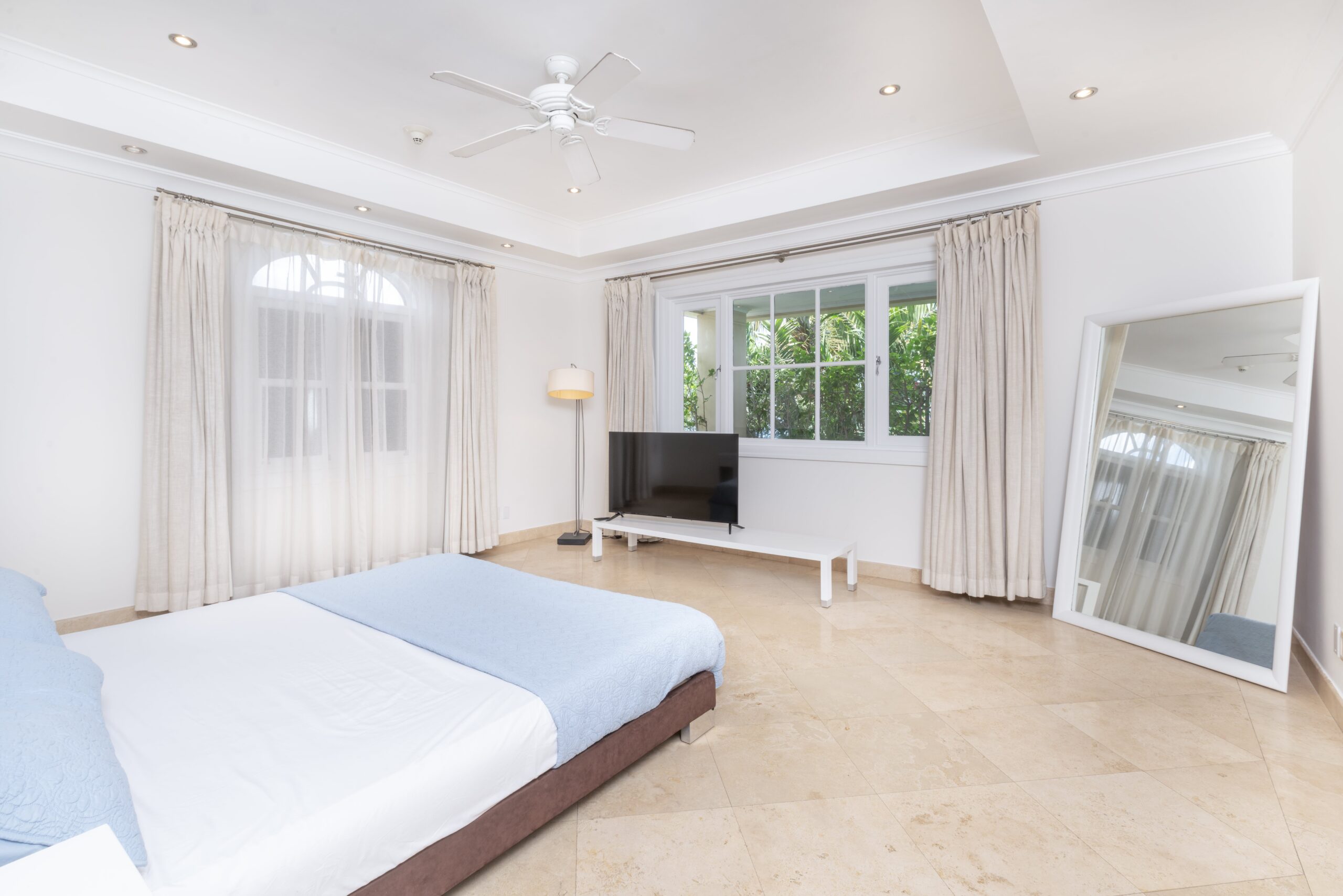 Bedroom with wall-mounted TV at Sandy Cove 201, St James