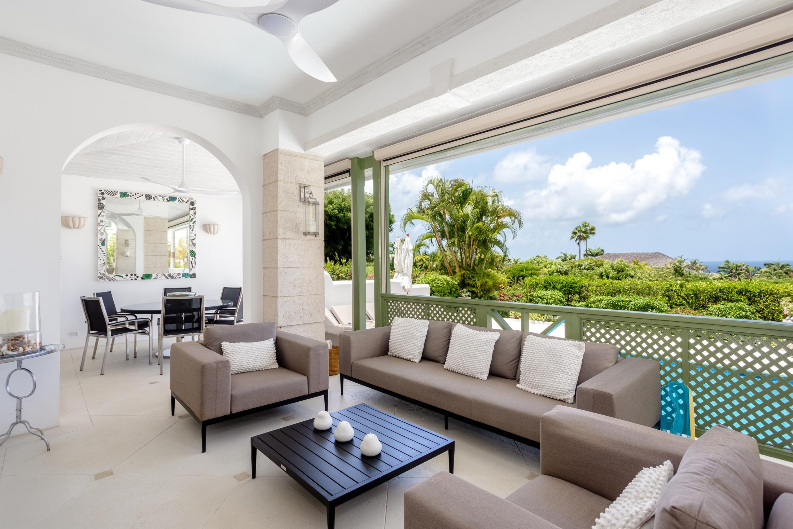 Living room opening to the terrace with sea views at Escape 2 Tamarind Row, Barbados